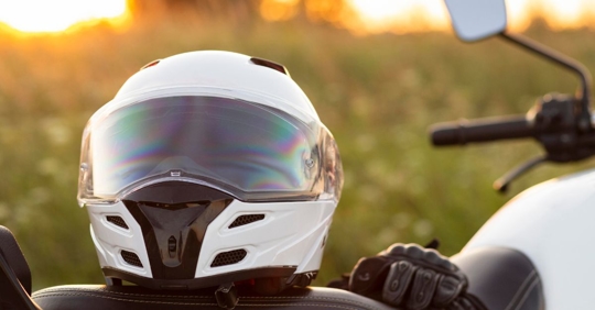 close up of a full-face motorcycle helmet sitting on the motorcycle seat
