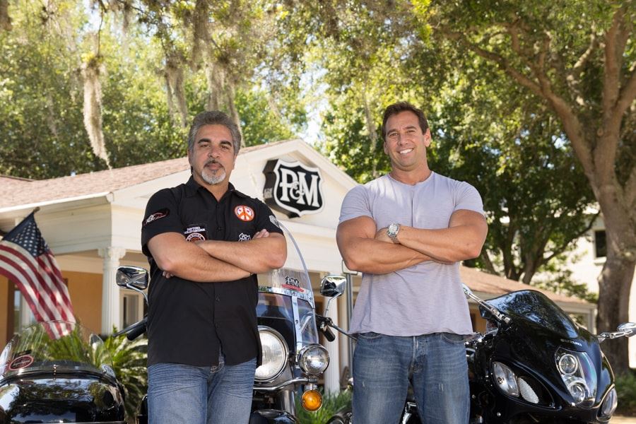 Attorneys Michael Politis & Mark Matovina standing in front of their motorcycles and the Politis & Matovina law office